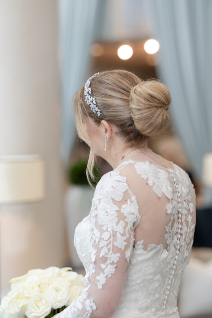 Bride walking inside downtown fidi hotel toward groom for first look