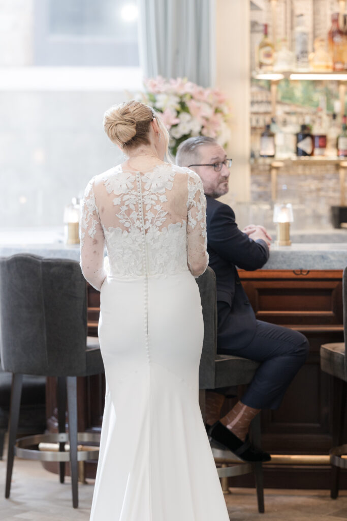 Bride walking inside downtown fidi hotel toward groom for first look