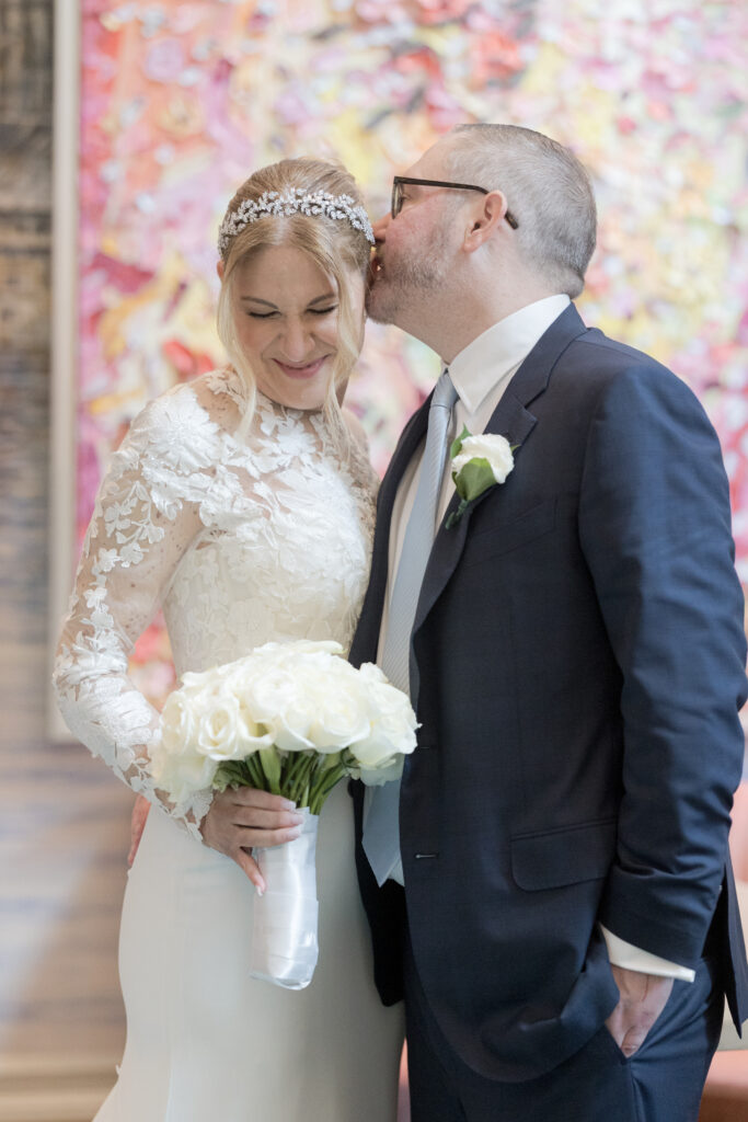 Bride and groom standing inside Wall Street Hotel portrait