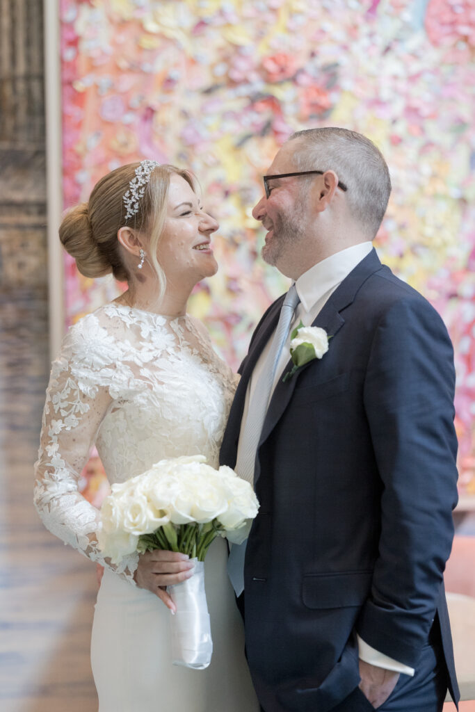 Bride and groom standing inside Wall Street Hotel portrait