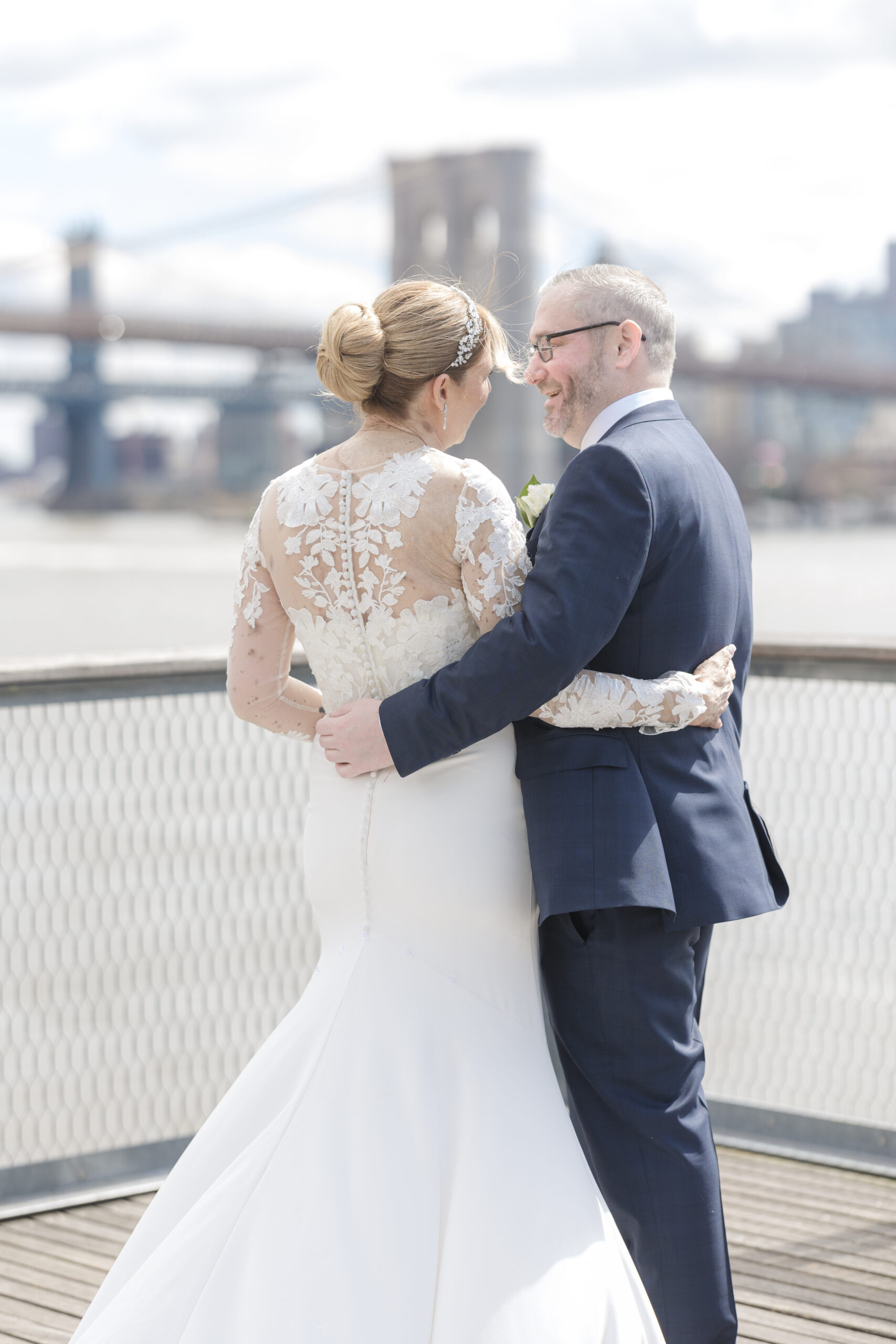 Bride and groom in front of Brooklyn Bridge at Pier 16