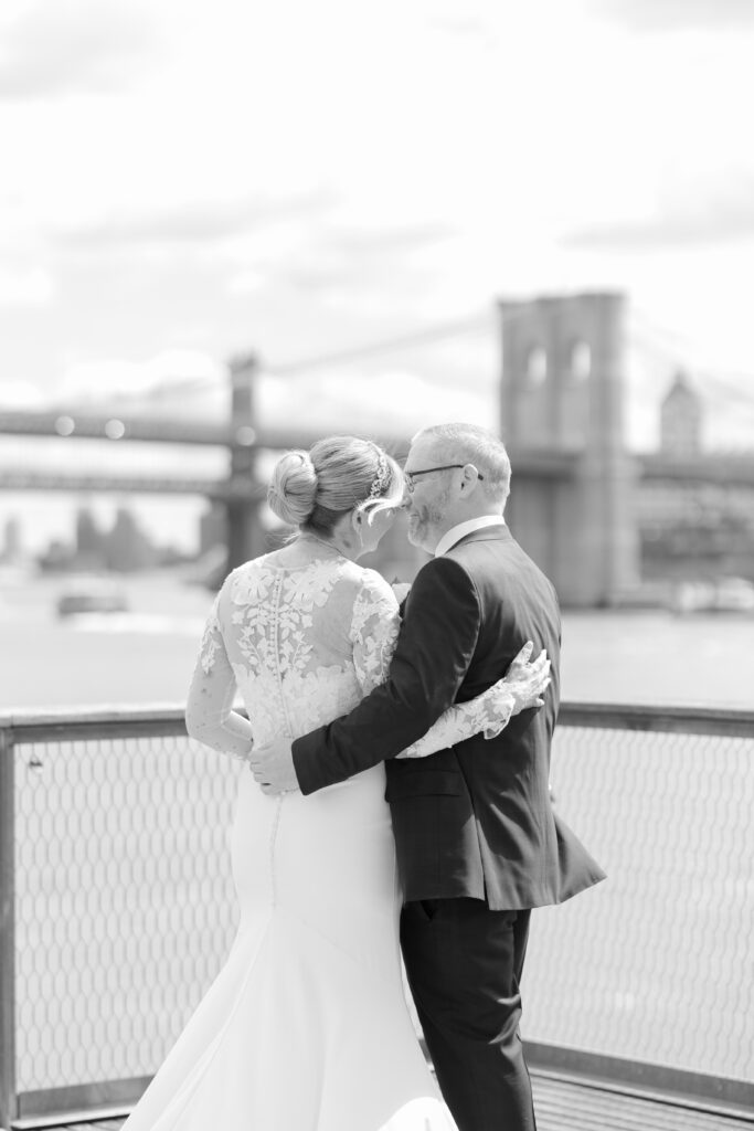 Bride and groom in front of Brooklyn Bridge at Pier 16