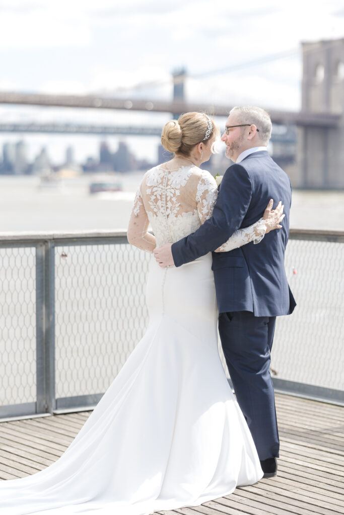 Bride and groom in front of Brooklyn Bridge at Pier 16