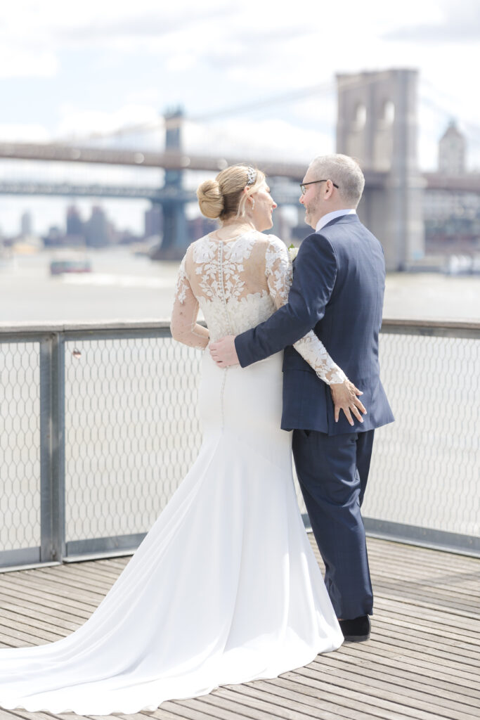 Bride and groom in front of Brooklyn Bridge at Pier 16