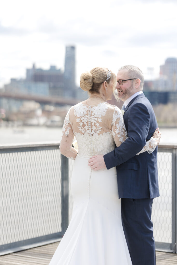 Bride and groom in front of Brooklyn Bridge at Pier 16