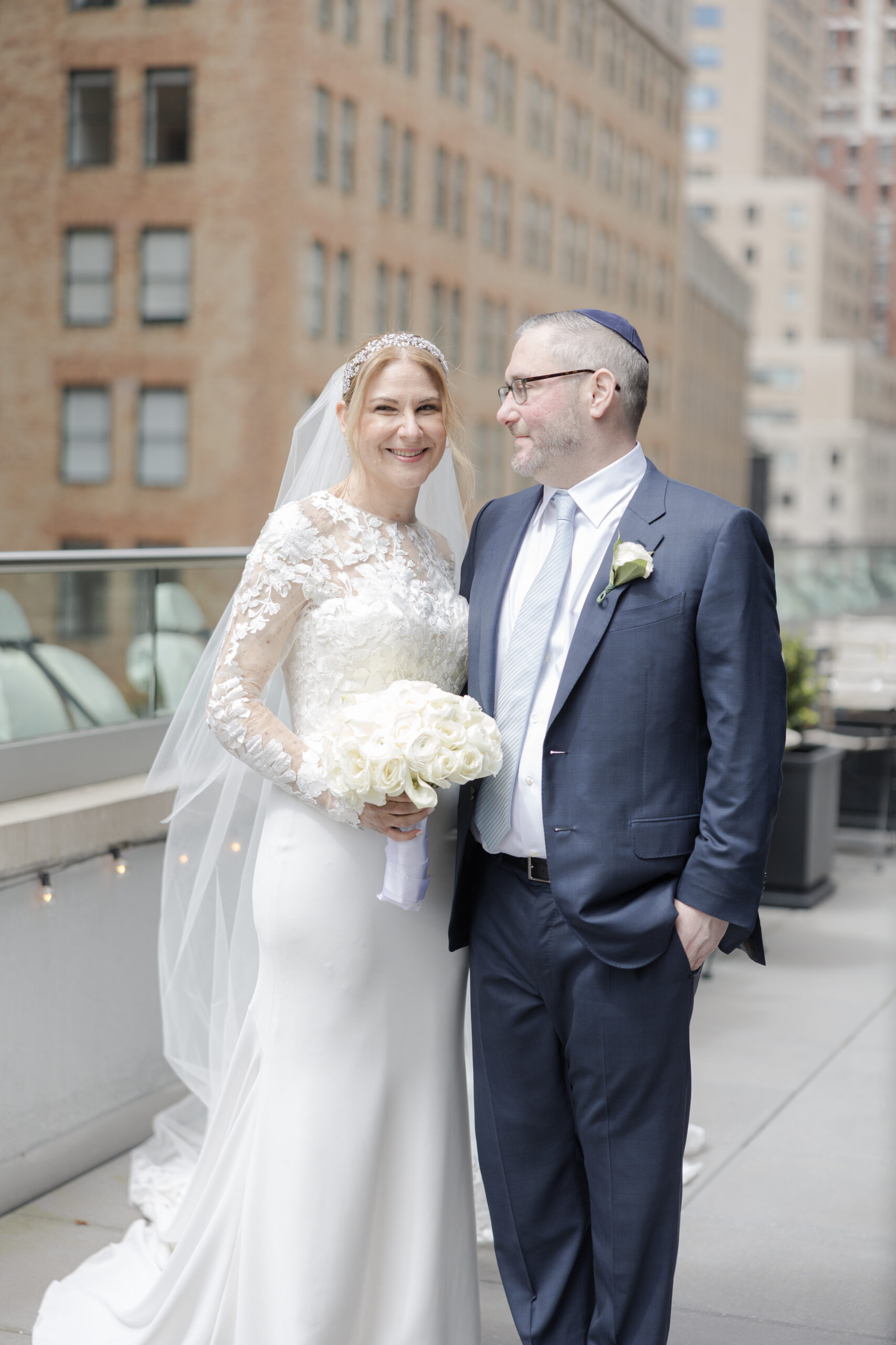 Bride and groom on the balcony of Wall Street Hotel Wedding Venue