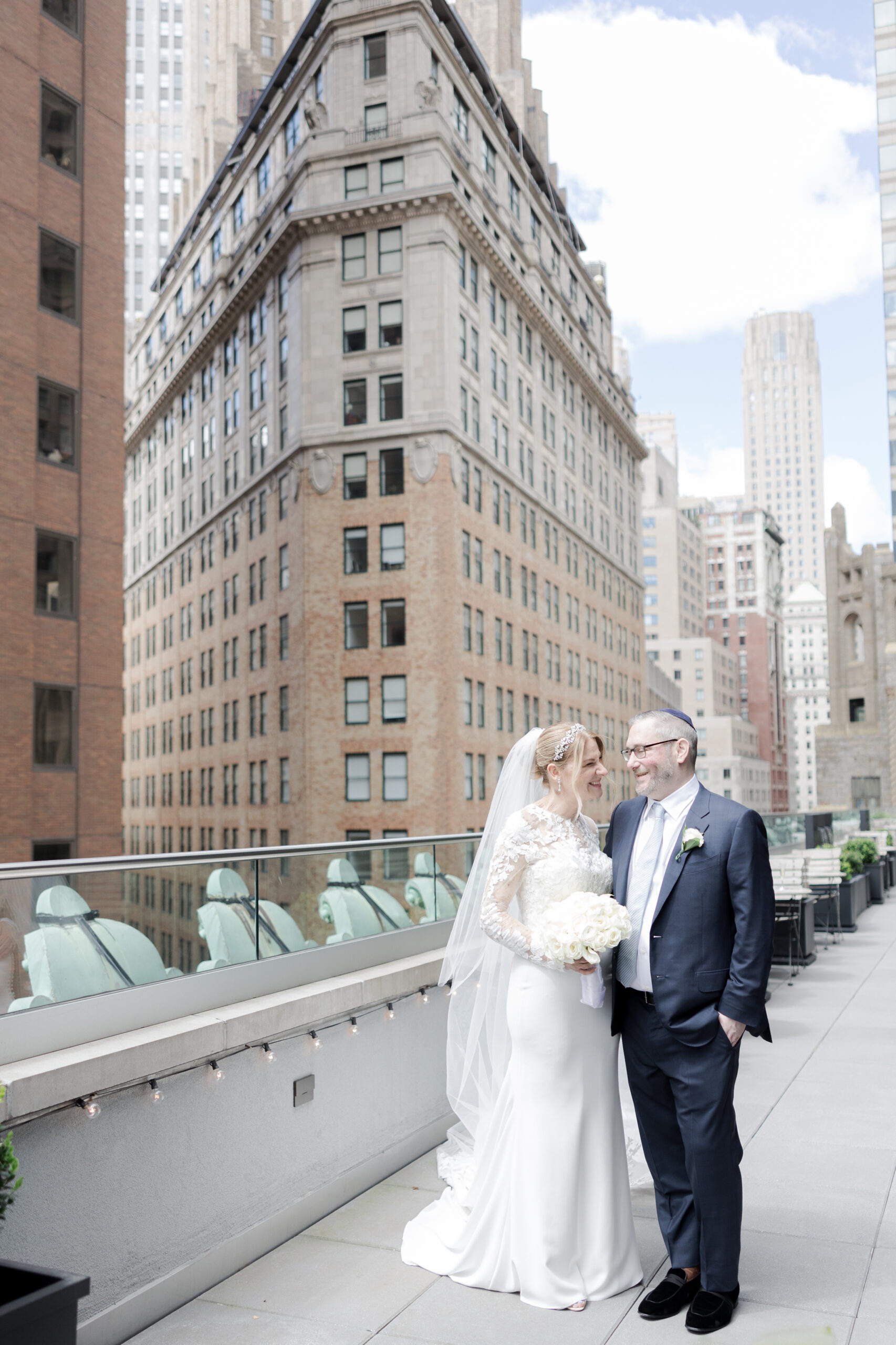 Bride and groom on the balcony of Wall Street Hotel Wedding Venue