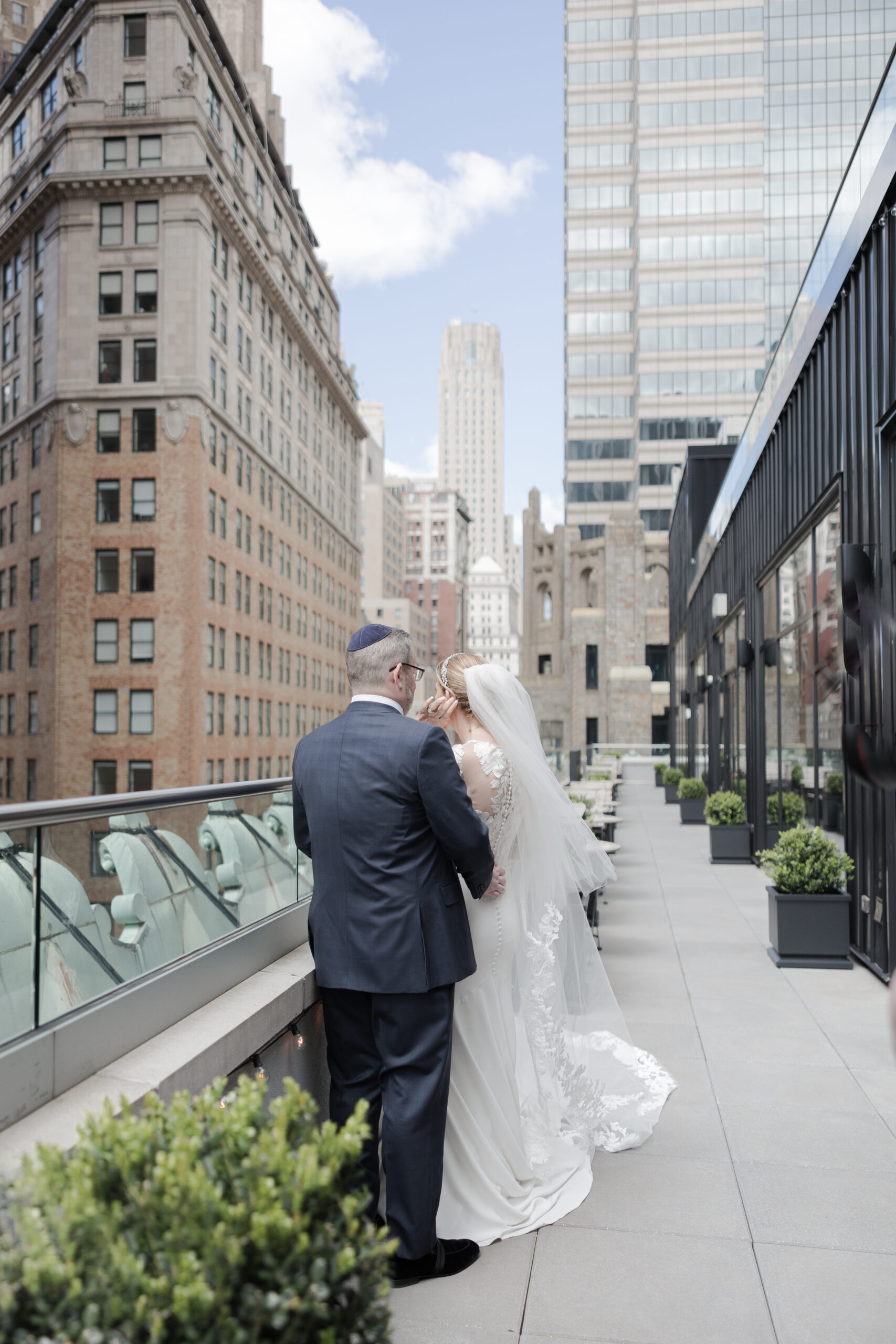 Bride and groom on the balcony of Wall Street Hotel Wedding Venue