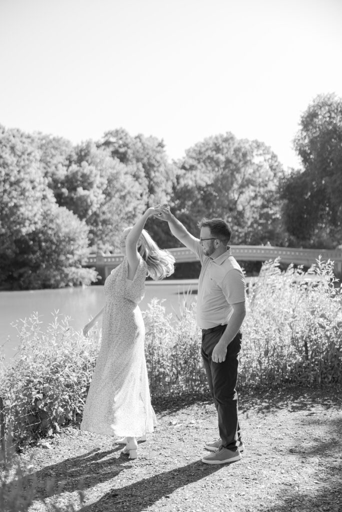 Black and white Central Park couple photos in front of Bow Bridge