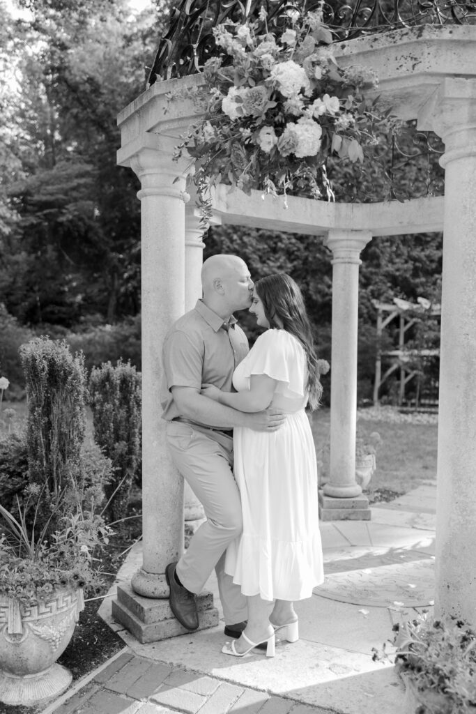 Black and white New Jersey couple photos leaning against gazebo