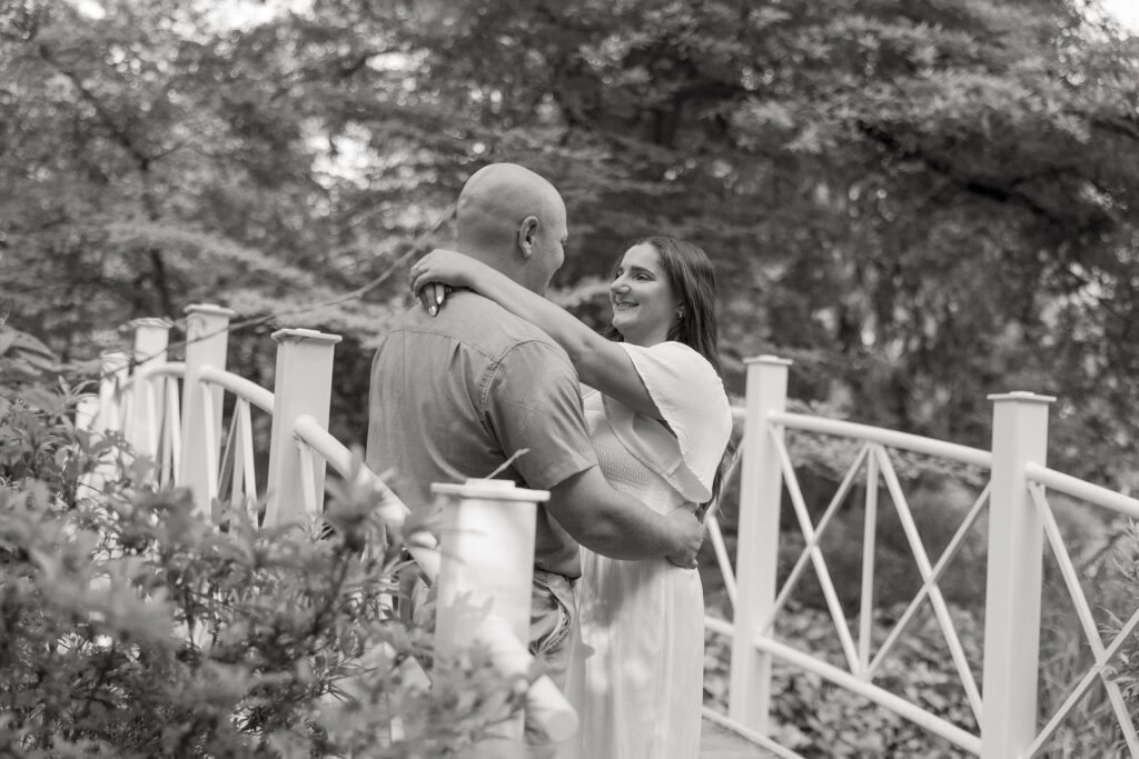 Black and white Sayen House and Gardens engagement photos on white bridge