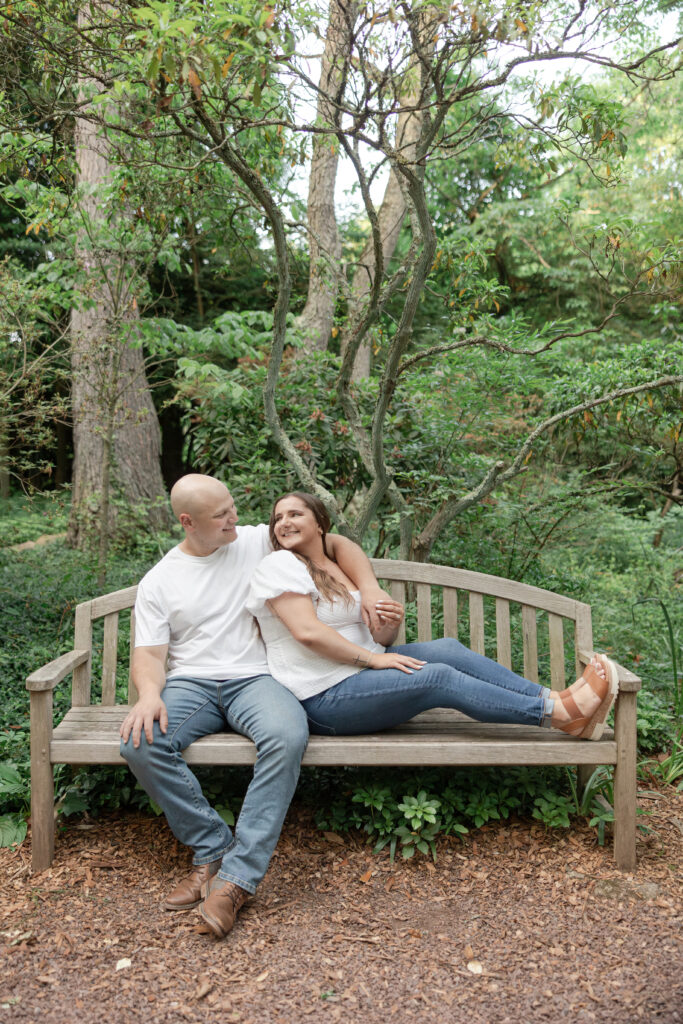 Engagement couple photos on bench at Sayen House and Gardens