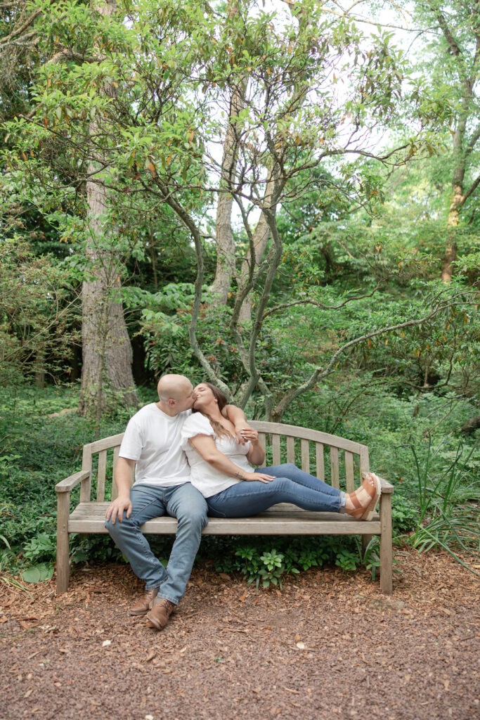 Engagement couple photos on bench at Sayen House and Gardens