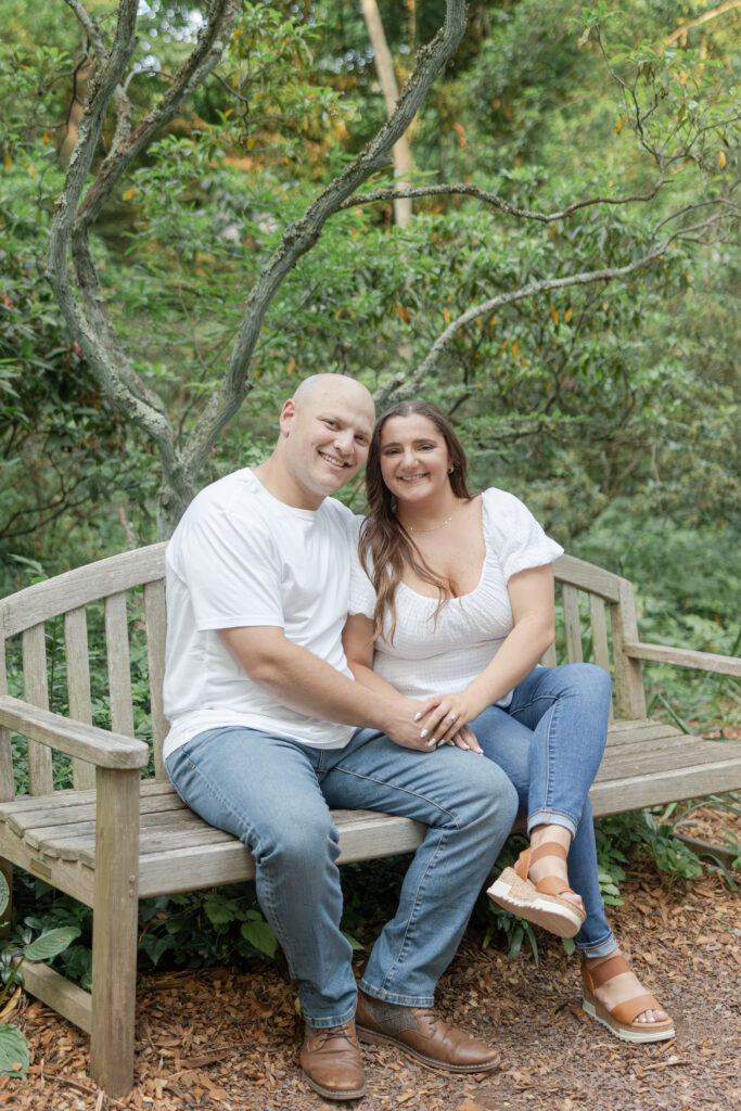 Engagement couple photos on bench at Sayen House and Gardens