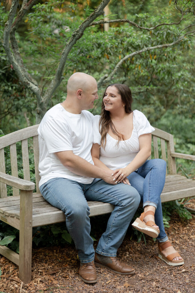 Engagement couple photos on bench at Sayen House and Gardens