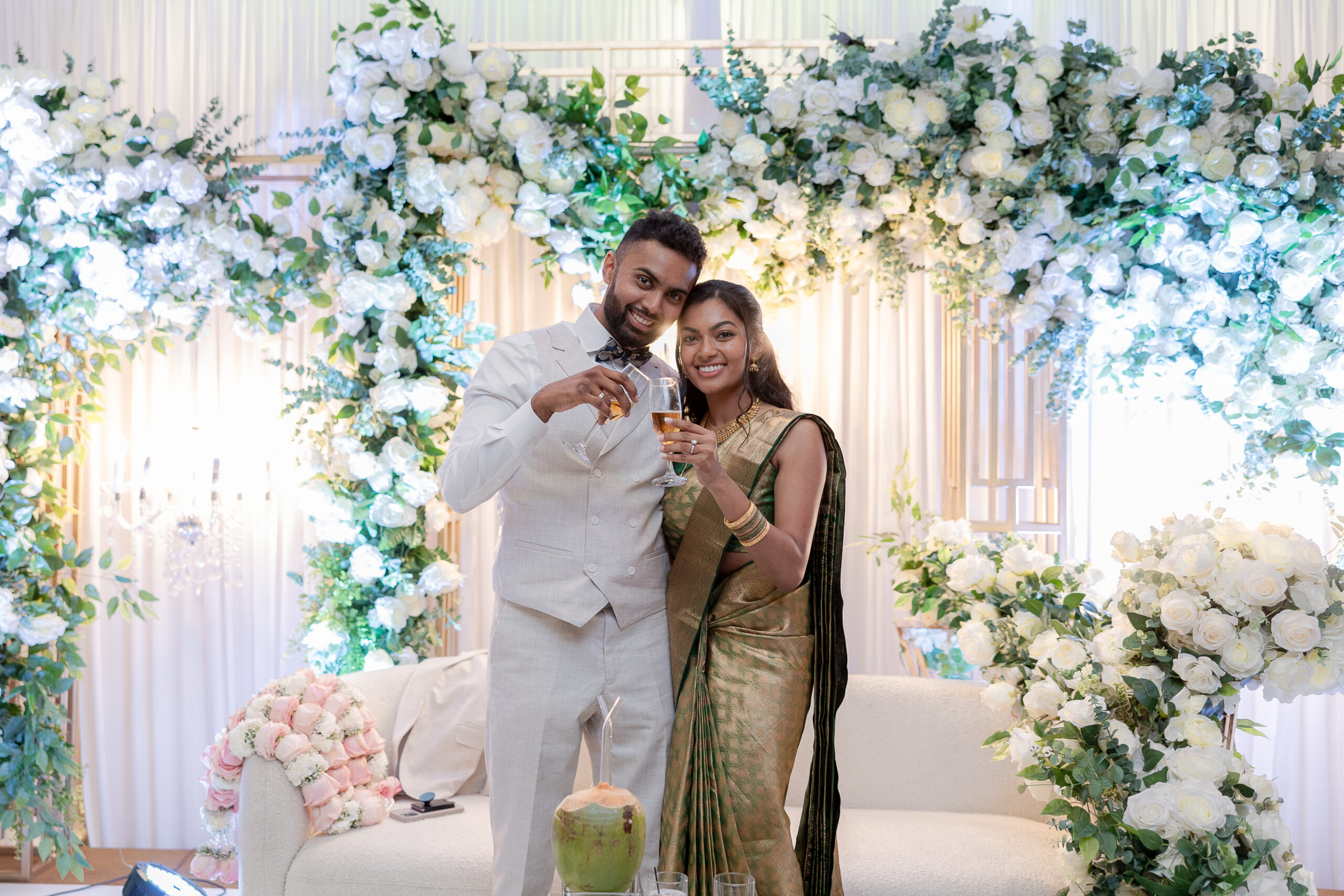 Bride and groom cheers at wedding reception