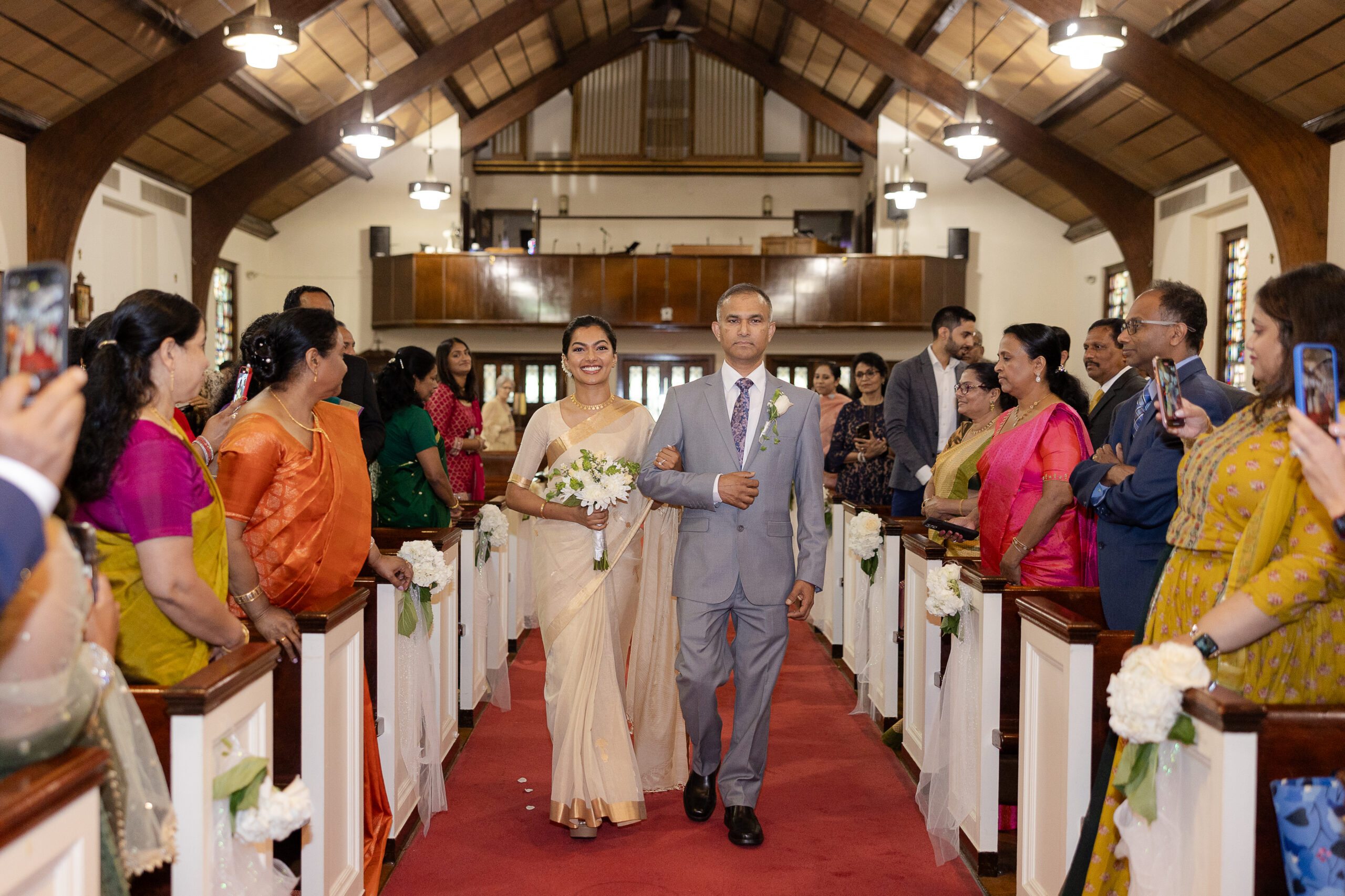 Bride walking down the aisle with dad for Indian wedding ceremony