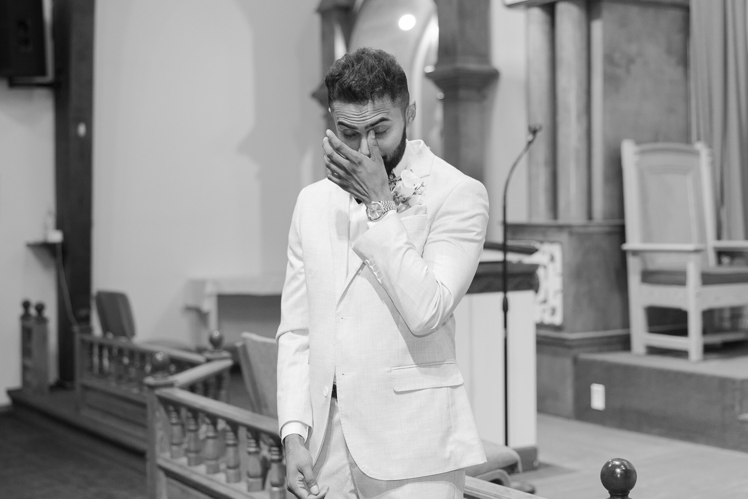 Black and white photo of groom reaction at Catholic Ceremony
