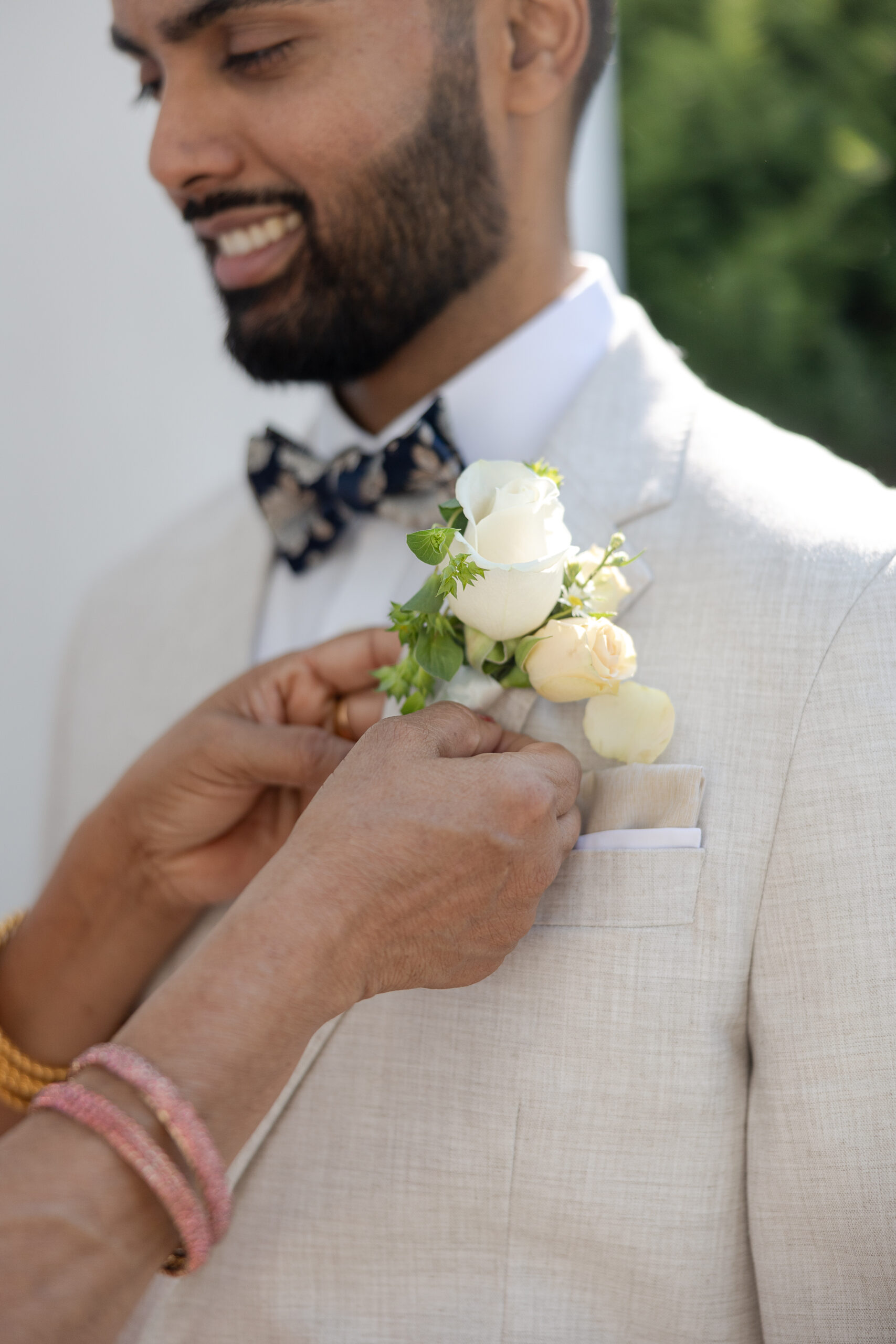 Groom getting dressed with mom for New York Catholic Indian Wedding