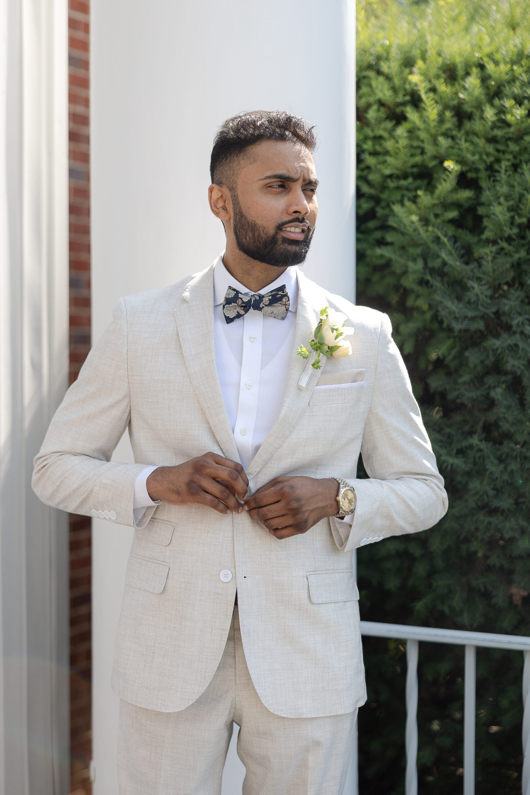 Groom in white wedding suit