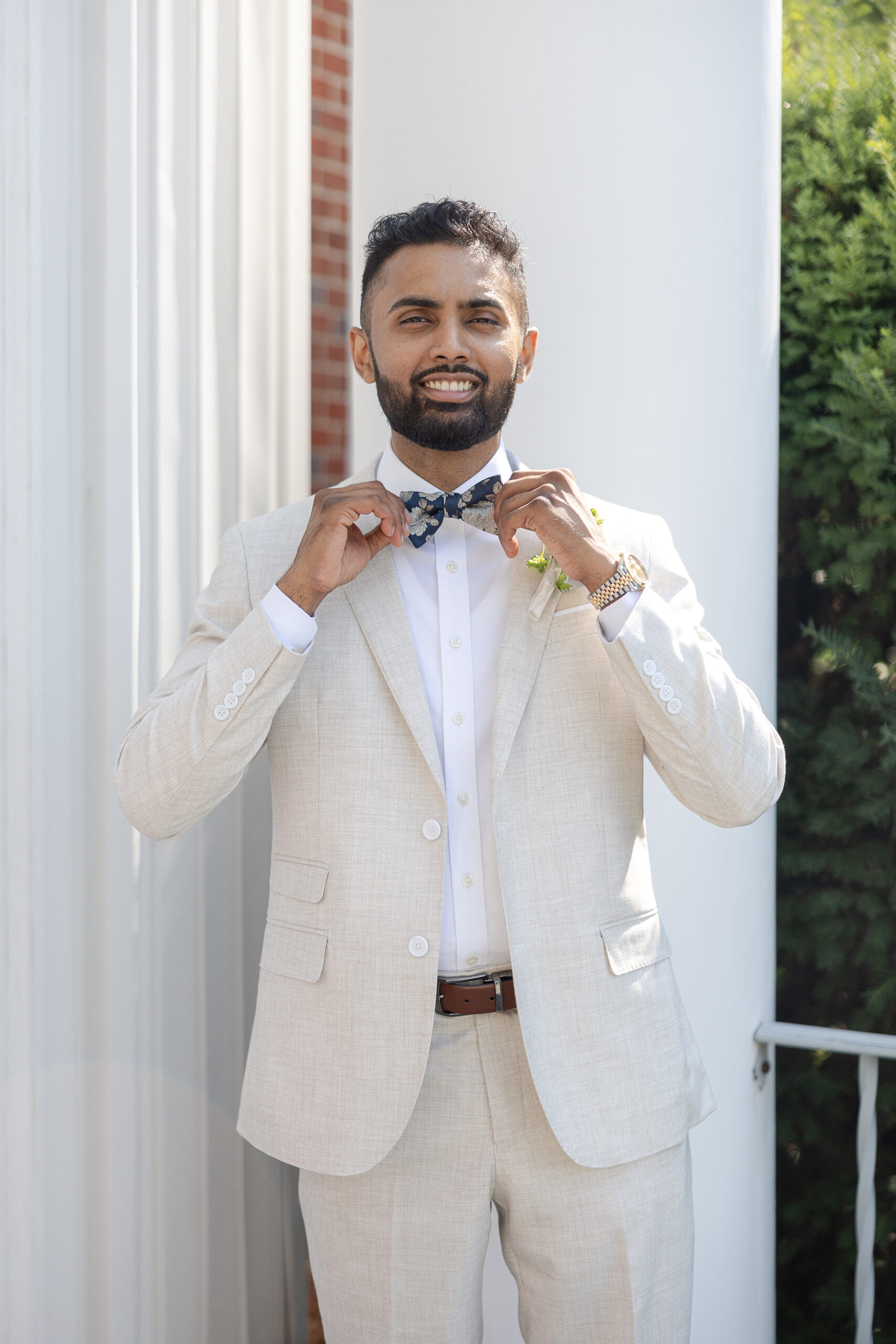 Groom in white wedding suit