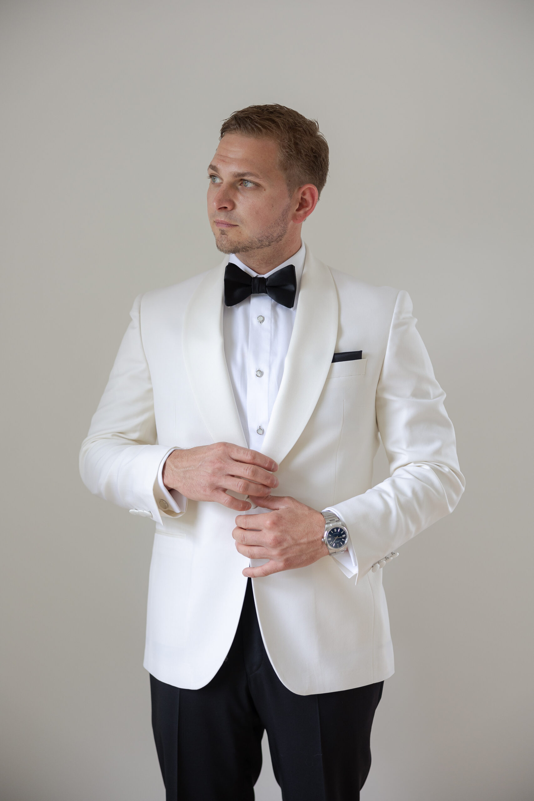 Groom getting dressed with white suit for New York Wedding day