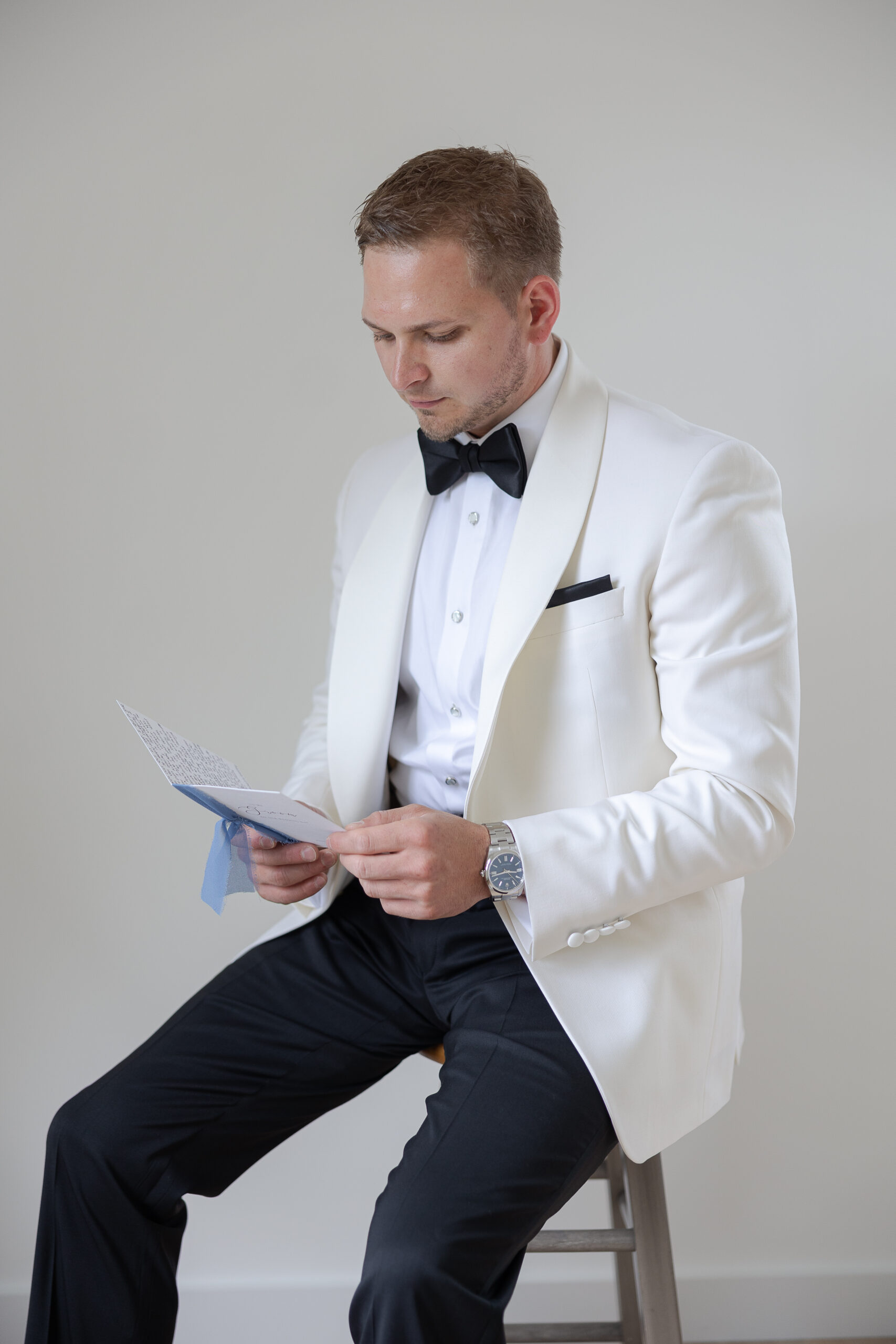 Groom reading bride's notes on wedding day