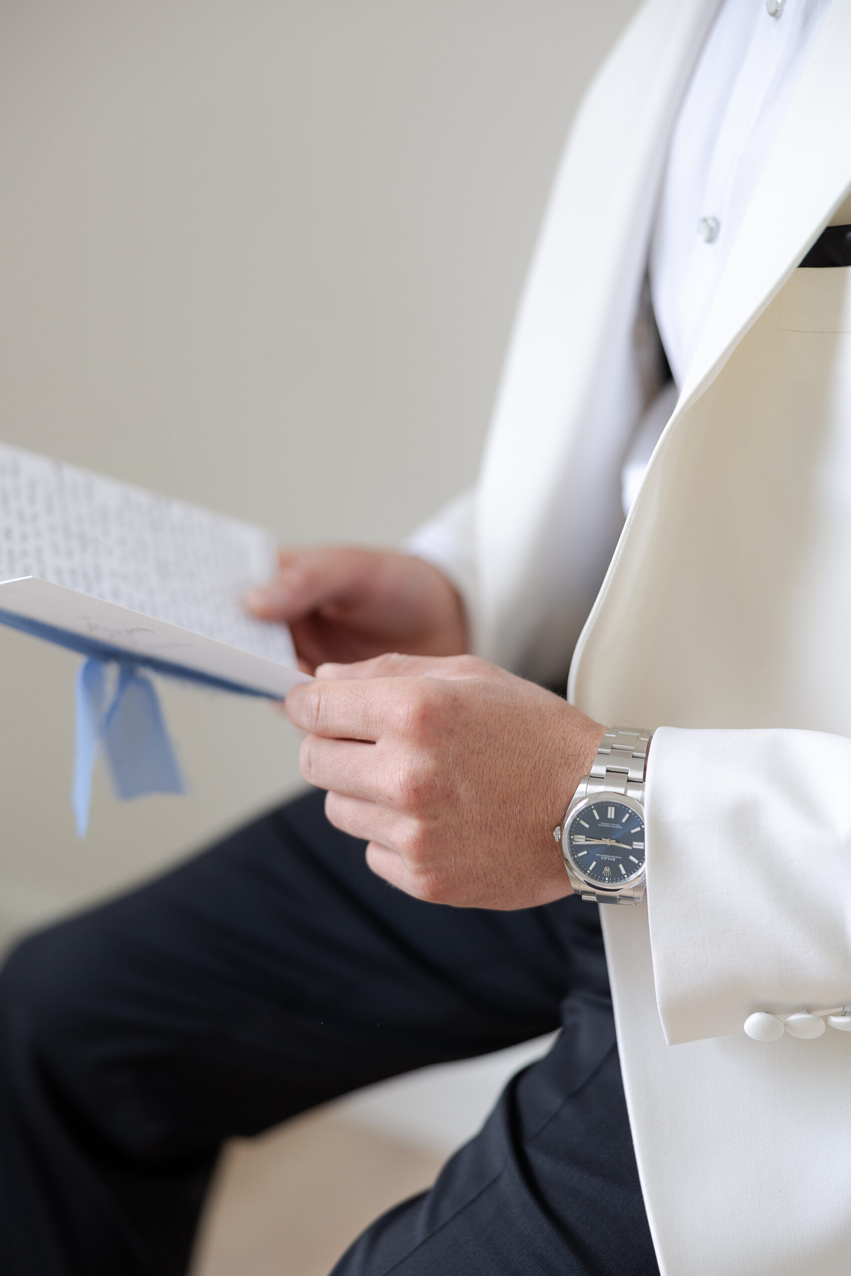 Groom reading bride's notes on wedding day