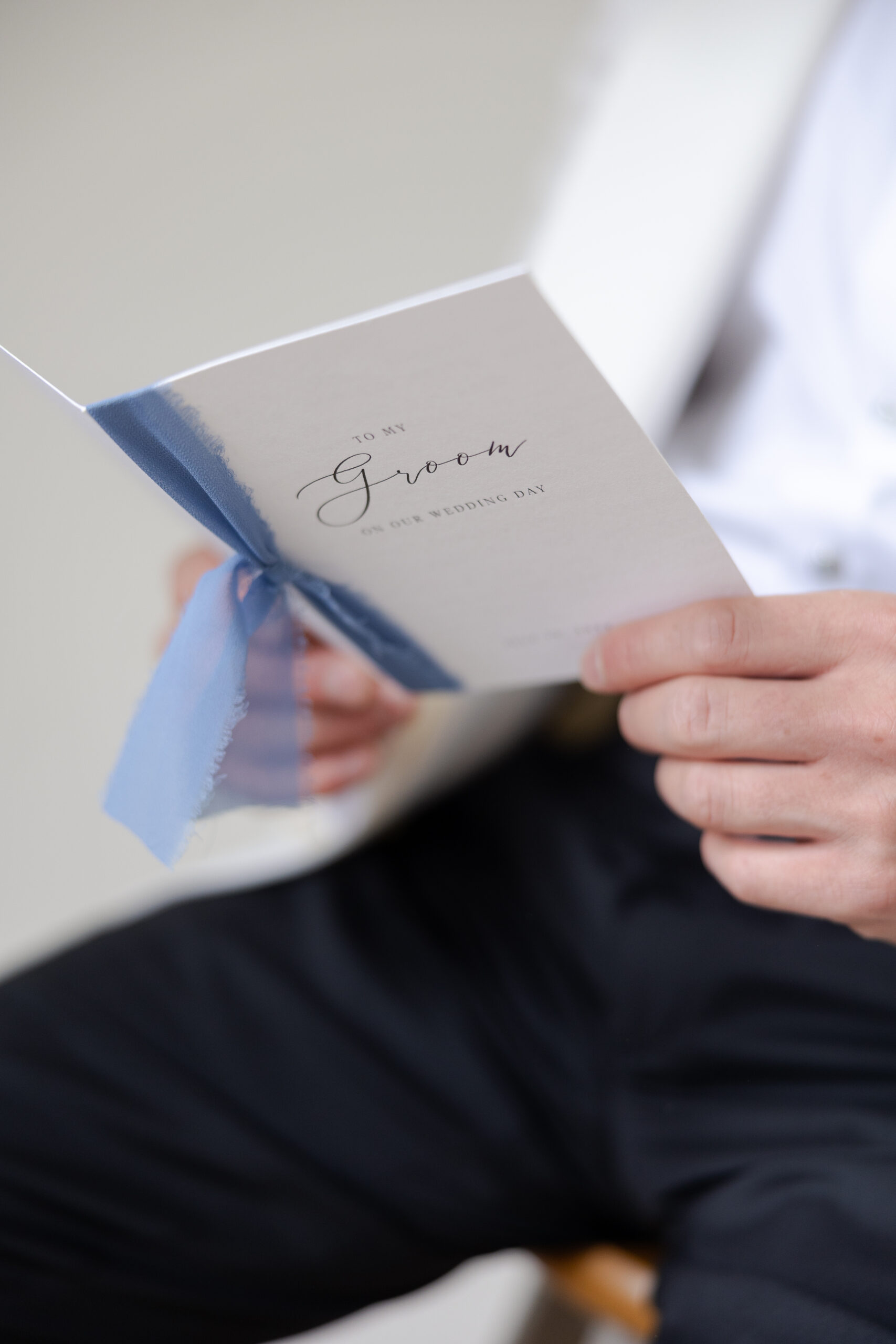 Groom reading bride's notes on wedding day