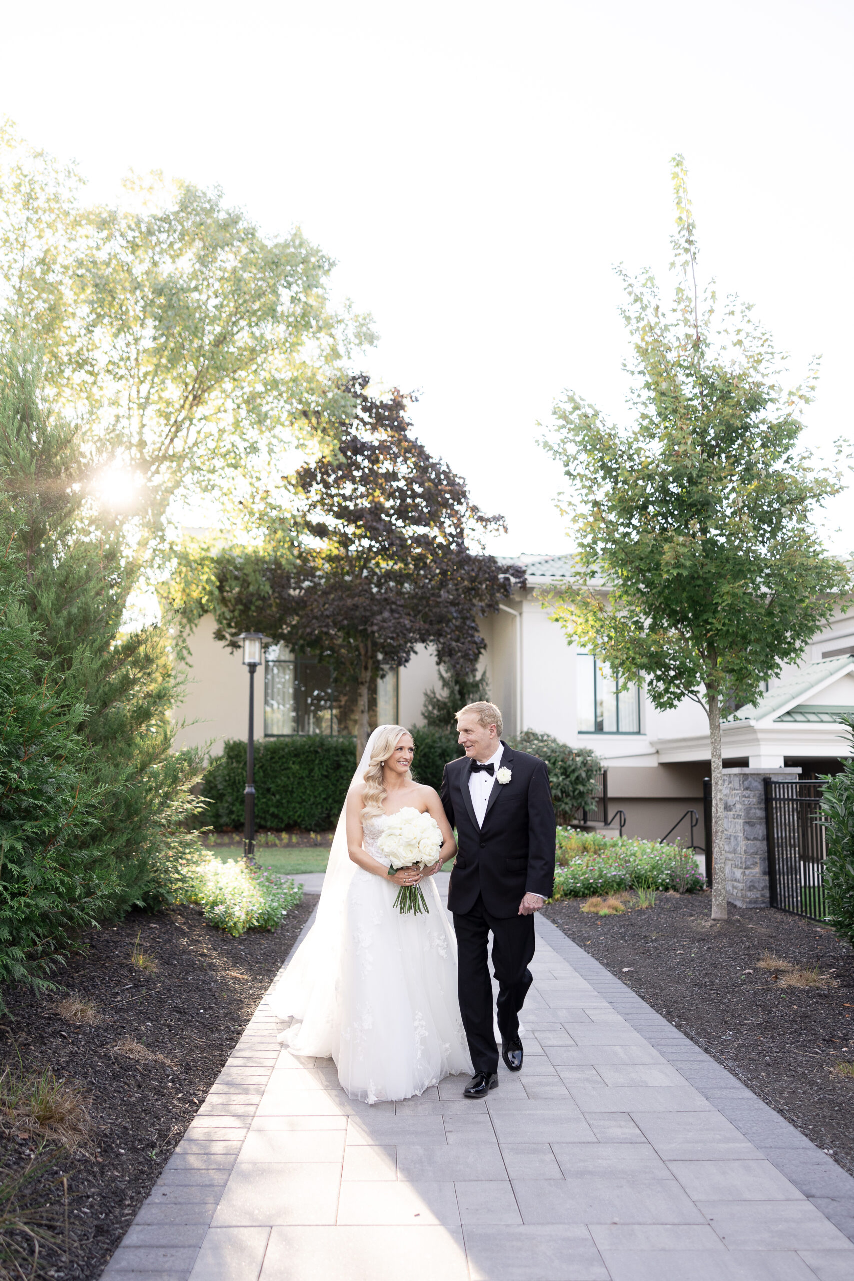 Bride and dad walking for outdoor wedding