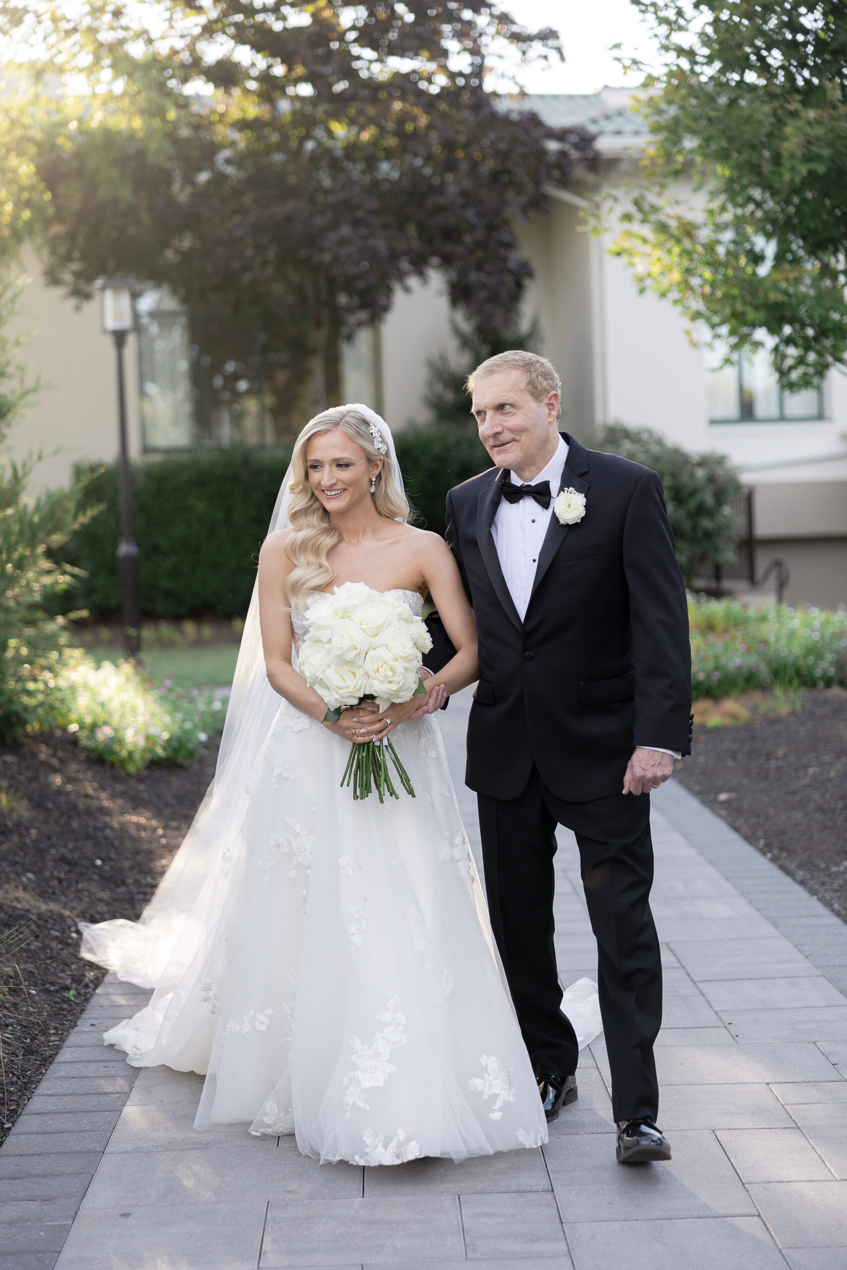 Bride and dad walking for outdoor wedding