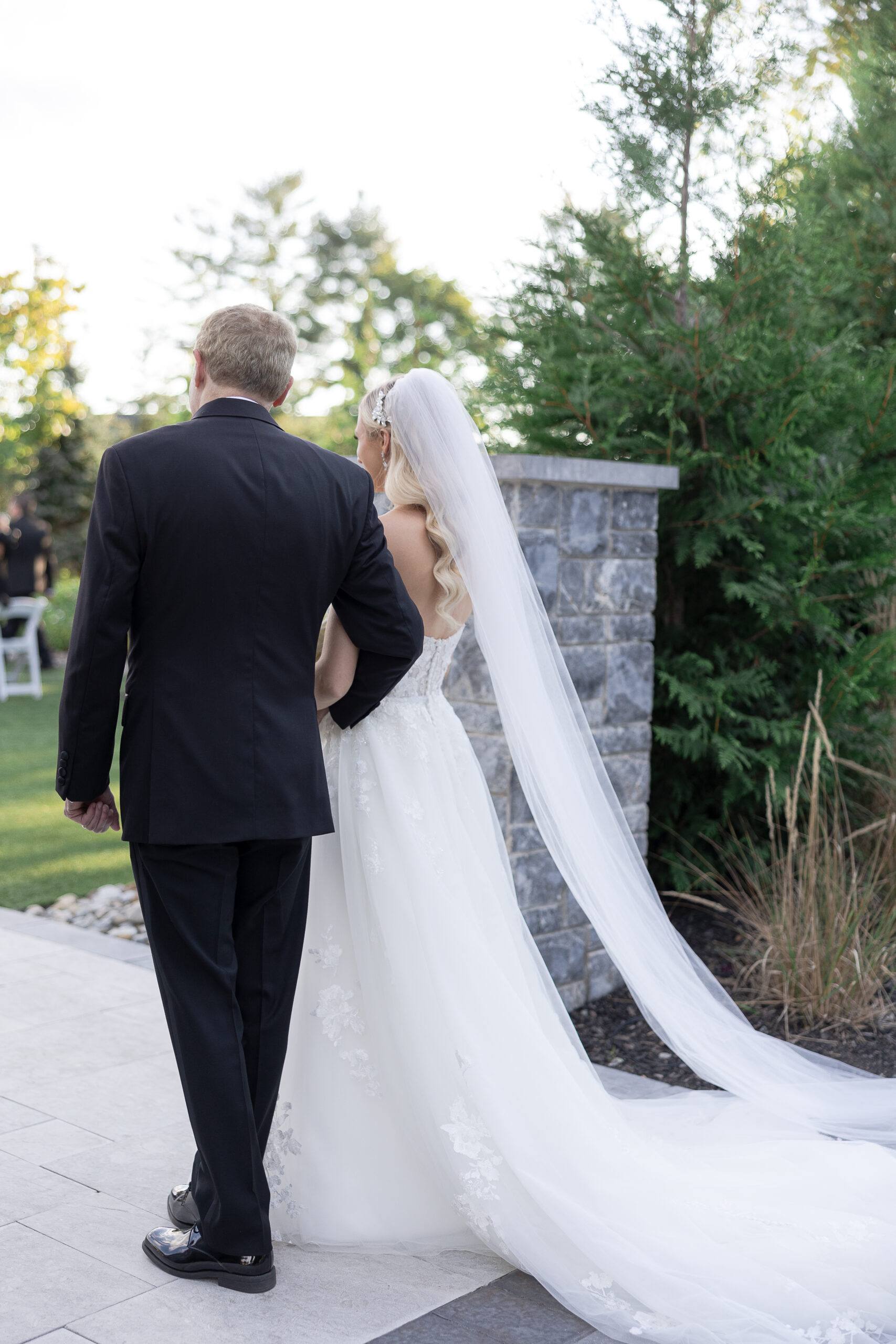 Bride and dad walking for outdoor wedding