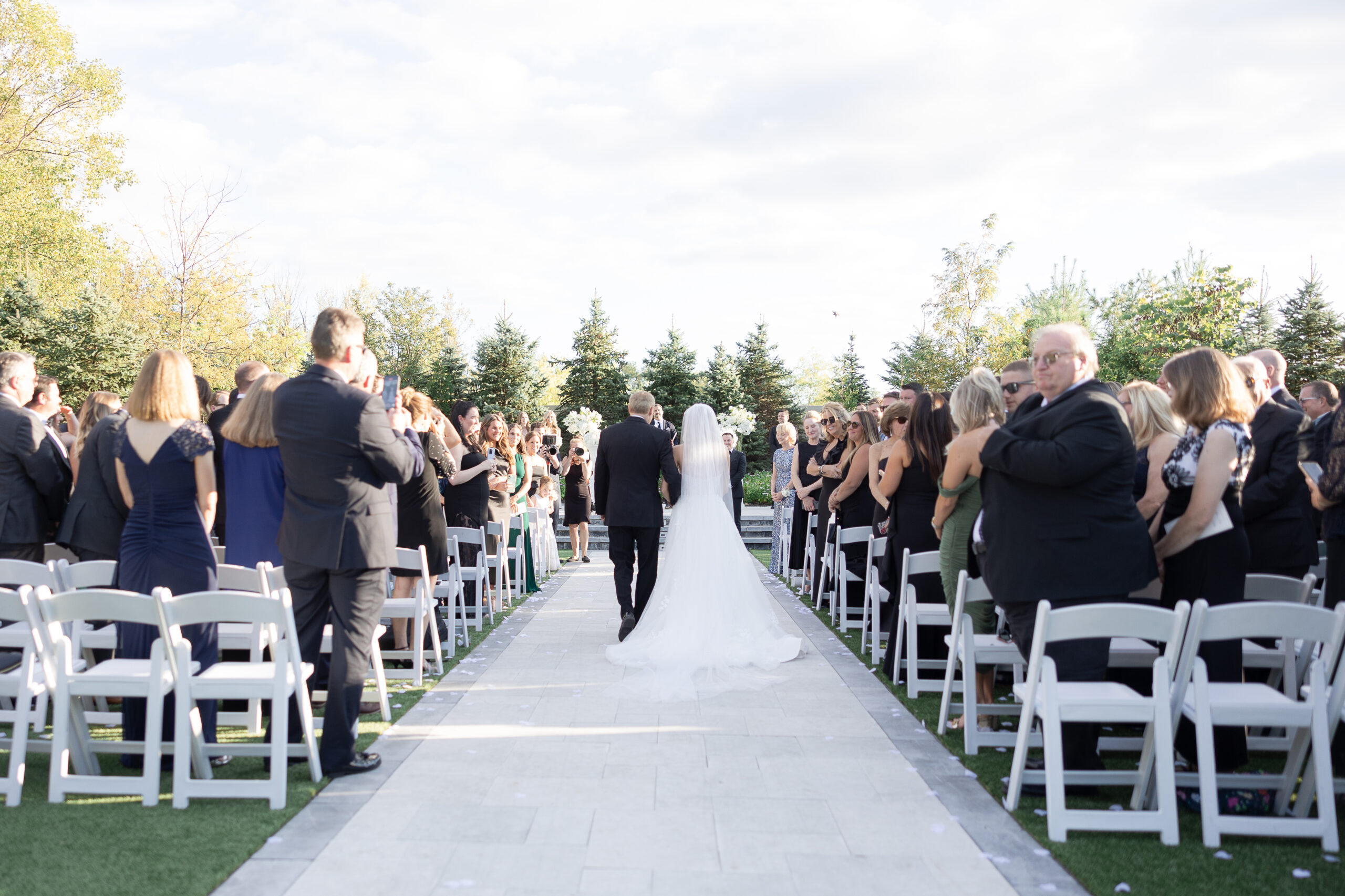 Bride and dad walking for outdoor wedding