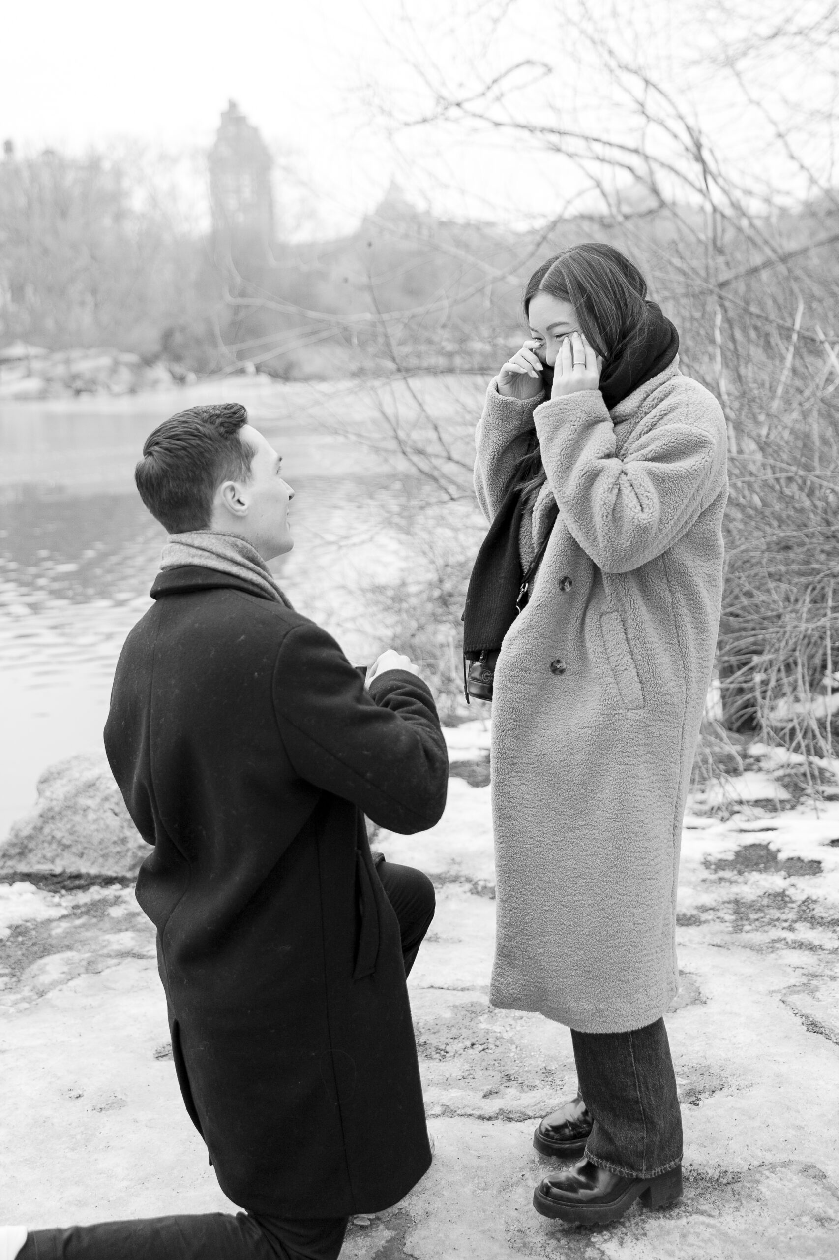 Black and white Central Park proposal with girlfriend engagement reaction