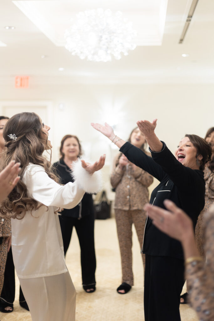 Bride and bridesmaid dancing at getting ready