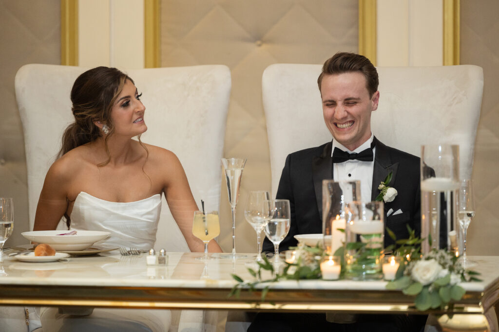 Bride and groom listening to speeches during reception