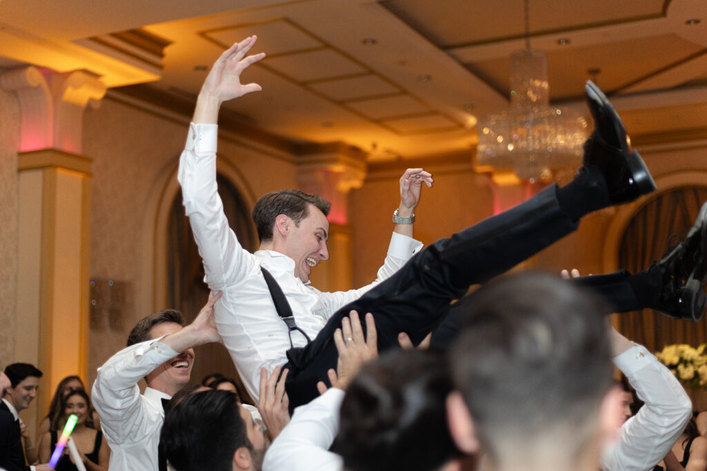 Bride and groom lifted up on a chair