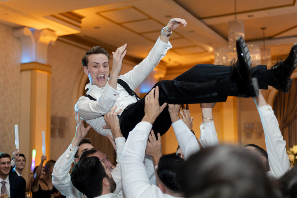 Bride and groom lifted up on a chair
