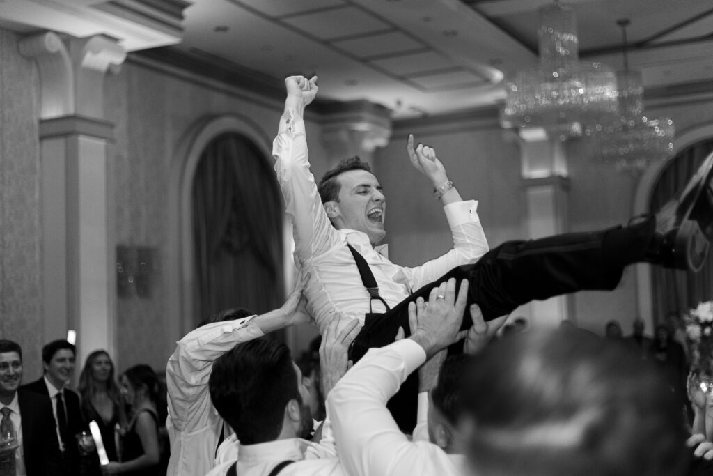 Bride and groom lifted up on a chair