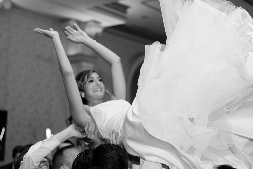 Bride and groom lifted up on a chair