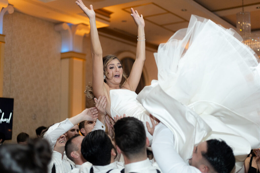 Bride and groom lifted up on a chair
