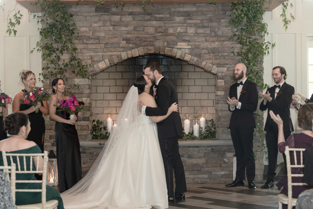 Bride and groom first kiss at wedding ceremony