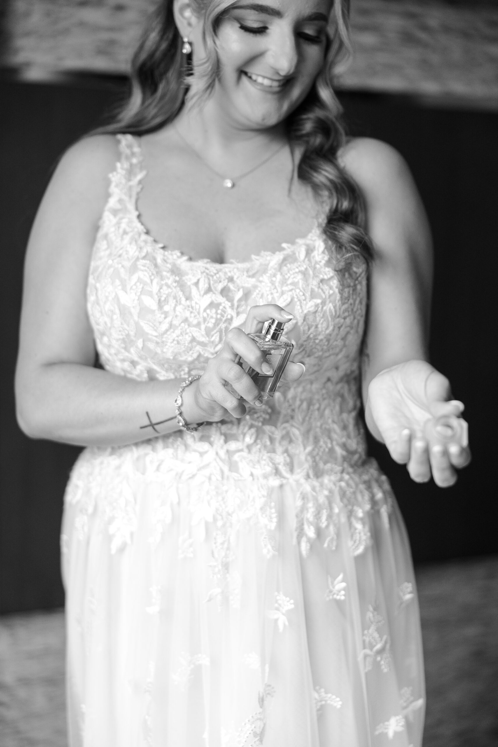 Bride putting on perfume