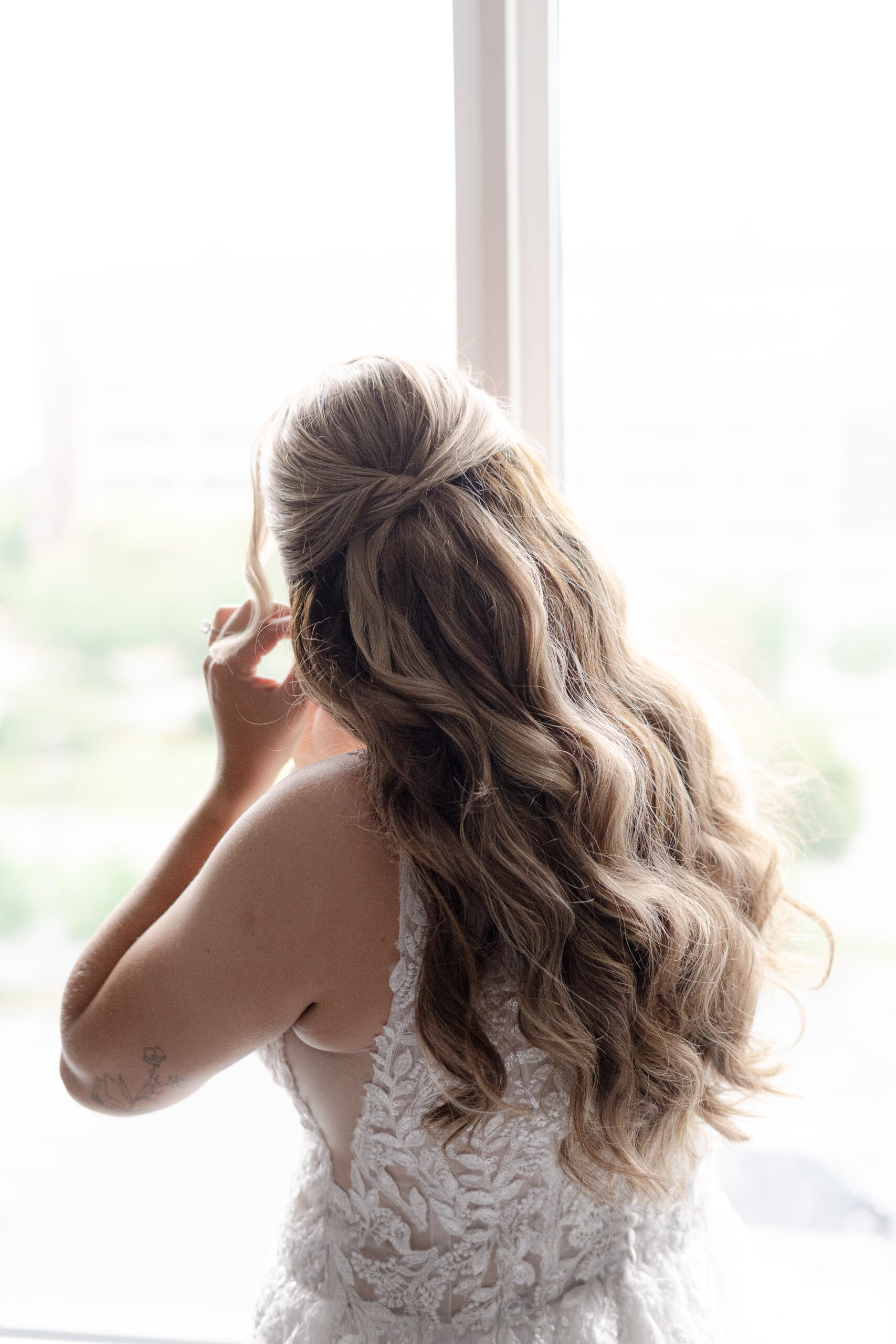 NJ bride putting on earring in Bridgewater Marriott