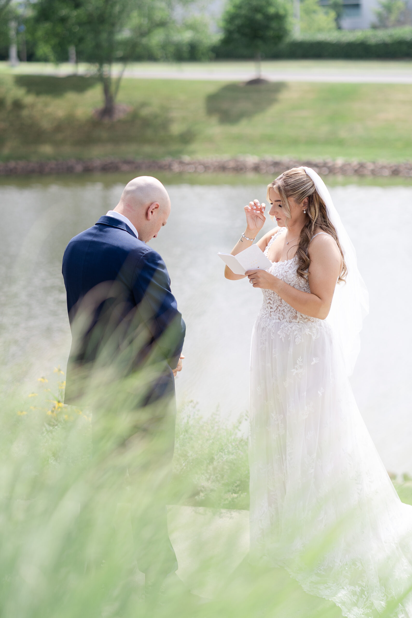 Bride reading outdoor private vows to groom