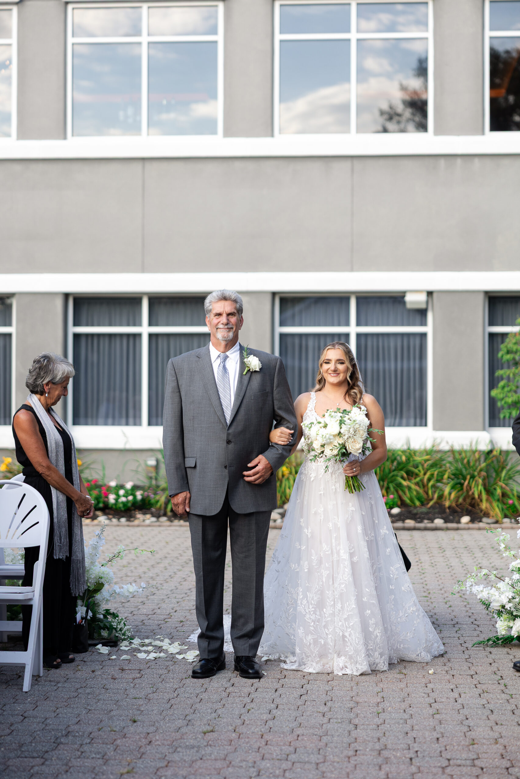 Bride walking down wedding ceremony aisle at Bridgewater Manor