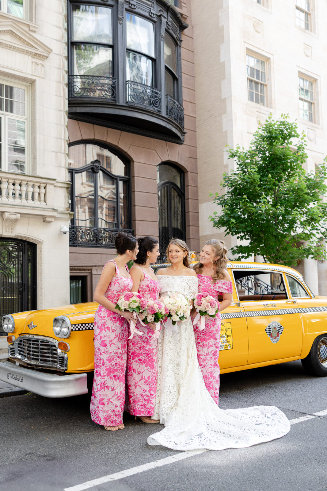 Wedding party in front of checker cab in NYC