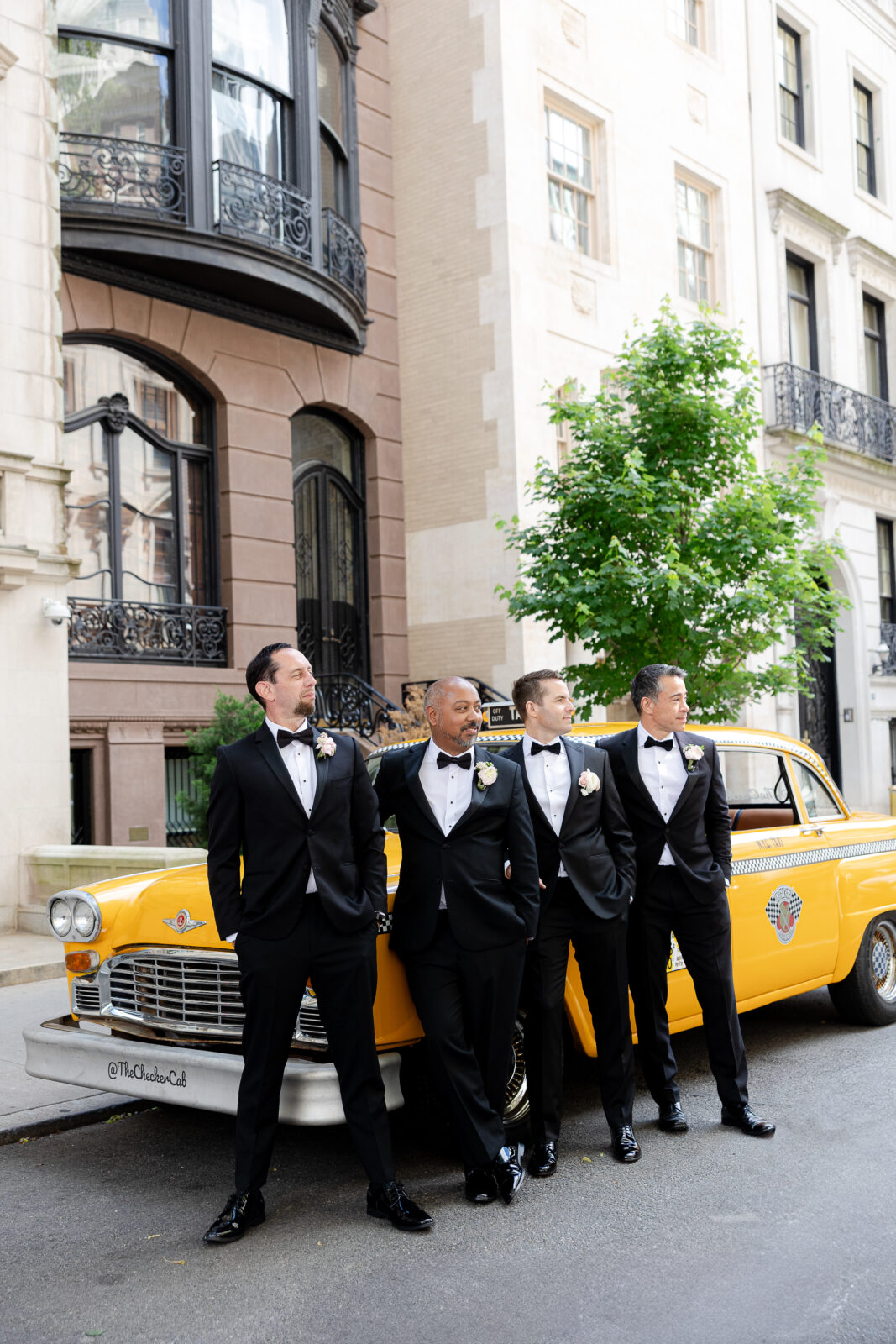 Wedding party in front of checker cab in NYC