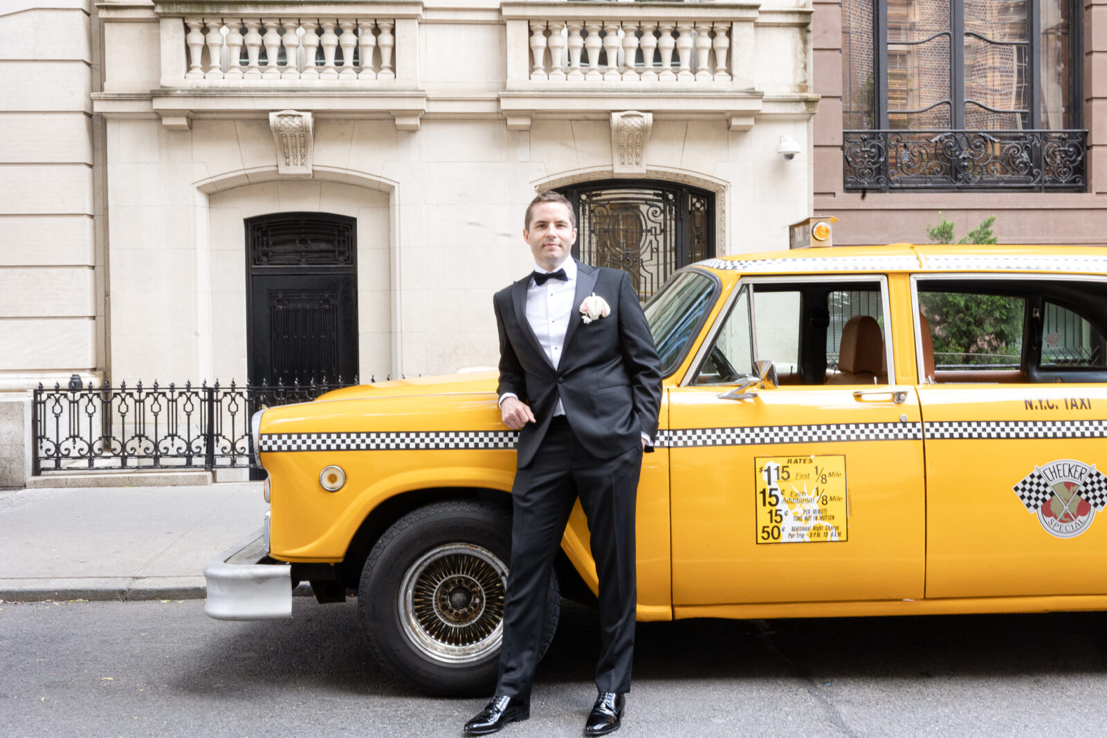Wedding party in front of checker cab in NYC
