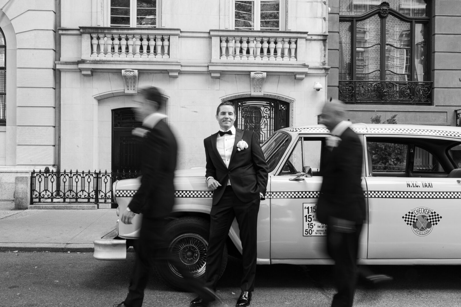 Wedding party in front of checker cab in NYC